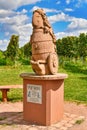 Wiesloch, Germany - Funny sculpture of wine god called `Speedy Bacchus` with blurry vineyard in background