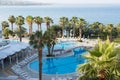 Wiev with lounges and palms near the pool Royalty Free Stock Photo