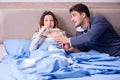 The wife caring for sick husband at home in bed Royalty Free Stock Photo