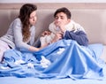 Wife caring for sick husband at home in bed