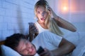 Wife Catching Cheating Husband Chatting On Smartphone Lying In Bed