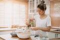 Wife cooking and prepare noodle meal for husband in the kitchen.