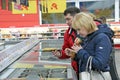 Wife and husband choose smoked mackerel in supermarket