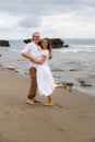 Wife and husband hug each other. Romantic couple in love. Family relation concept. Barefoot couple on the beach during sunset time Royalty Free Stock Photo