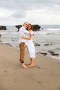 Wife and husband hug each other. Romantic couple in love. Family relation concept. Barefoot couple on the beach during sunset time Royalty Free Stock Photo