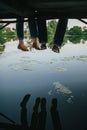 Wife with husband sitting in canoe on coast of lake in sunny morning Royalty Free Stock Photo