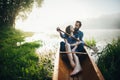 Wife with husband sitting in canoe in morning