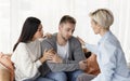 Wife And Psychologist Comforting Addicted Husband At Psychotherapy Session Indoor Royalty Free Stock Photo