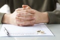 Wife signs divorce decree form with ring