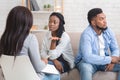 Wife Sitting Next To Her Displeased Husband And Talking To Counselor Royalty Free Stock Photo