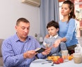 Wife and son asking husband for more money Royalty Free Stock Photo