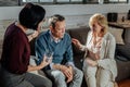 Wife and therapist sitting around shocked husband Royalty Free Stock Photo