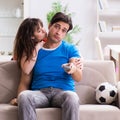 Wife unhappy that husband is watching football