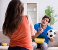 Wife unhappy that husband is watching football