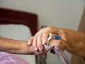 Wife visiting husband in hospital. Senior couple holding hands on hospital bed for hospitalization for supporting his dear. Concep Royalty Free Stock Photo