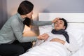 Wife visiting and take care her sick husband while he sleeping on bed at home Royalty Free Stock Photo