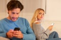 Wife Watching Husband Texting On Phone Suspecting Infidelity Sitting Indoor Royalty Free Stock Photo