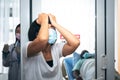 wife wearing a surgical mask Under stress because African American husband sick from Covid-19 or Coronavirus infection