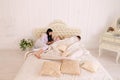 Wife yelling at daughter, husband sleeping on white bed in room Royalty Free Stock Photo