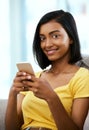 Wifi all weekend. Portrait of a teenage girl using a cellphone at home. Royalty Free Stock Photo