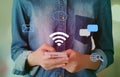 Wifi and digital network data icon over hand using smart phone b Royalty Free Stock Photo