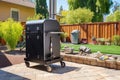 a wifi enabled bbq smoker on a backyard patio