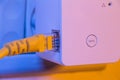 WiFi extender in electrical socket on the wall with ethernet cab Royalty Free Stock Photo