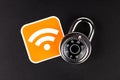 WiFi wireless network security simple abstract concept. Wifi Connection signal symbol and a coded padlock laying on black Royalty Free Stock Photo