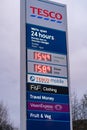 Wigan, UK: March 10, 2022: Large illuminated sign at entrance to Tesco supermarket car park showing company logo