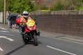 WIGAN, UK 14 SEPTEMBER 2019: A photograph documenting a race support motorbike leading the Tour of Britain 2019 race as it passes
