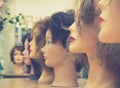 Wigs on mannequin heads in a row. Royalty Free Stock Photo