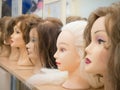 Wigs on mannequin heads in a row. Royalty Free Stock Photo