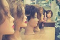 Wigs on mannequin heads in a row. Royalty Free Stock Photo