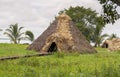 Wigwam, an Indian hut from plant stems, against a background of green tropical vegetation, reconstruction Royalty Free Stock Photo