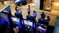 Wii staff demonstrates with people playing car racing game