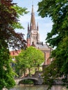 Wijngaard bridge over canal and tower of Church of our Lady, Onze-Lieve-Vrouwekerk, in Bruges, Belgium