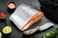 Wild Alaskan Sockeye or Coho Salmon fillet, on black dark stone table background