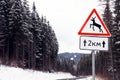 Wild animals warning traffic sign near road with snow on sides Royalty Free Stock Photo