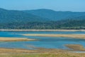 Wild asian elephant family or herd with baby elephants or calf at scenic view and landscape of ramganga river in dhikala corbett Royalty Free Stock Photo