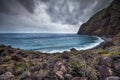 Wild bay on the Madeira island, dark clouds and turquoise sea