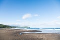 Wild beach made of volcanic sand on the Pacific Ocean, Kamchatka Peninsula, Russia. Royalty Free Stock Photo