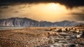 Wild beach over mountains and dramatic sky.