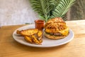 Wild beef burger with melted cheddar cheese, lettuce, crispy onion and vegetable stew garnished Royalty Free Stock Photo