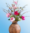 Wild bouquet with peonies against a blue background.