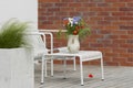 Wild flower bouquet (Cornflowers, chamomiles wheat and poppies) in terracotta vase on summer terrace.. Royalty Free Stock Photo