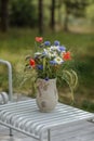 Wild flower bouquet (Cornflowers, chamomiles wheat and poppies) in terracotta vase. Royalty Free Stock Photo