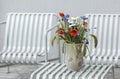 Wild flower bouquet (Cornflowers, chamomiles wheat and poppies) in terracotta vase. Royalty Free Stock Photo