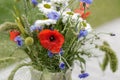 Wild flower bouquet (Cornflowers, chamomiles wheat and poppies) in terracotta vase. Royalty Free Stock Photo