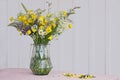 wild flower bouquet in glass vase on table Royalty Free Stock Photo