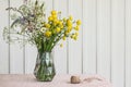 Wild flower bouquet in glass vase on table Royalty Free Stock Photo